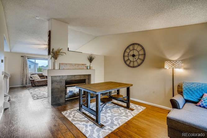 11181 Rodeo Circle Parker, CO 80138 - Photo 4 of 26 a living room with furniture and a fireplace