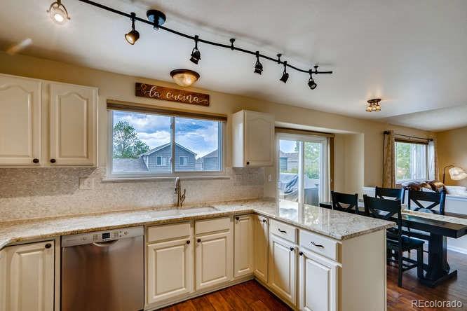 11181 Rodeo Circle Parker, CO 80138 - Photo 8 of 26 a open kitchen with stainless steel appliances granite countertop a sink and a cabinets