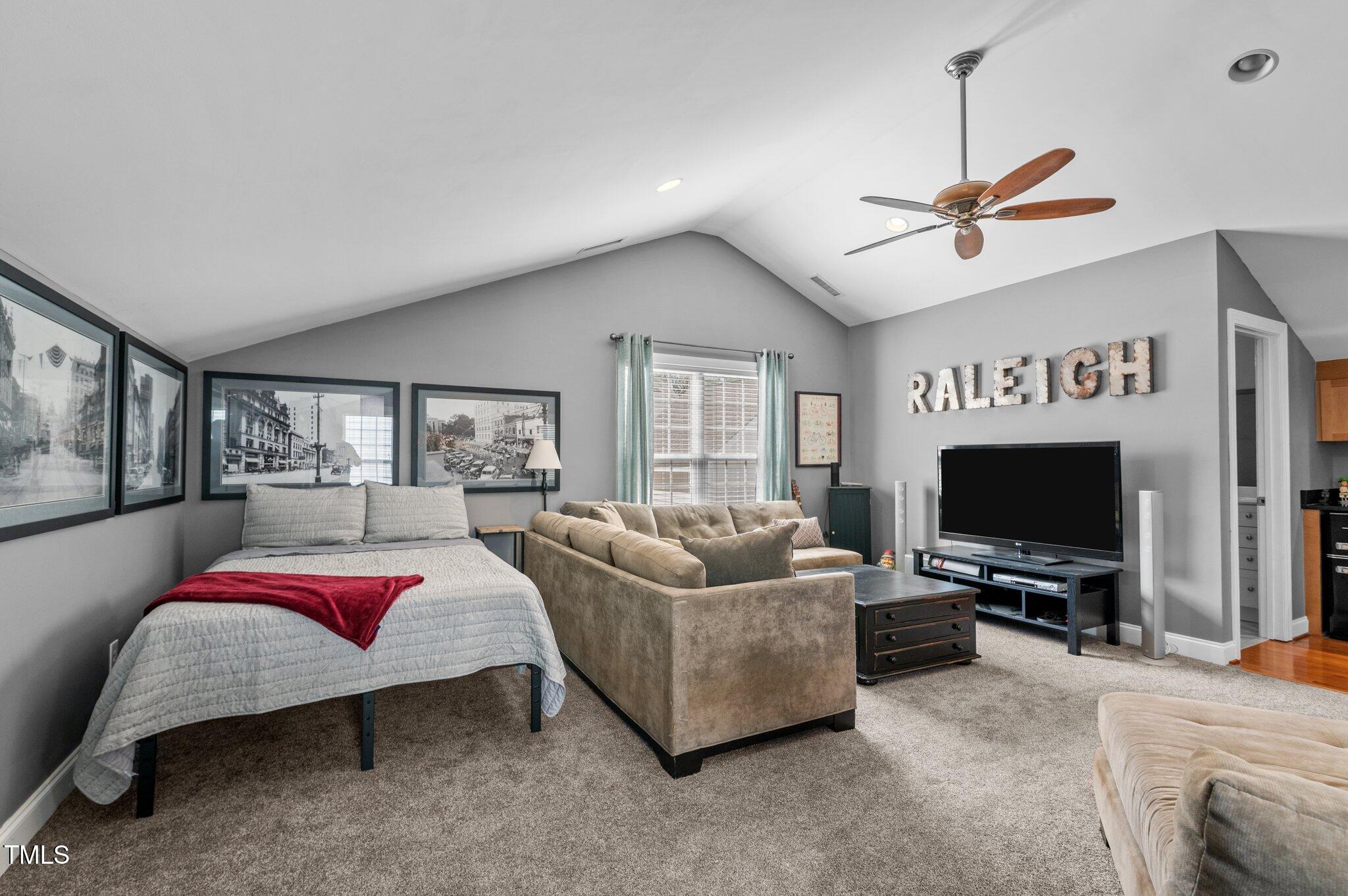 1209 Harp Street Raleigh, NC 27604 - Photo 20 of 39 a living room with furniture and a flat screen tv