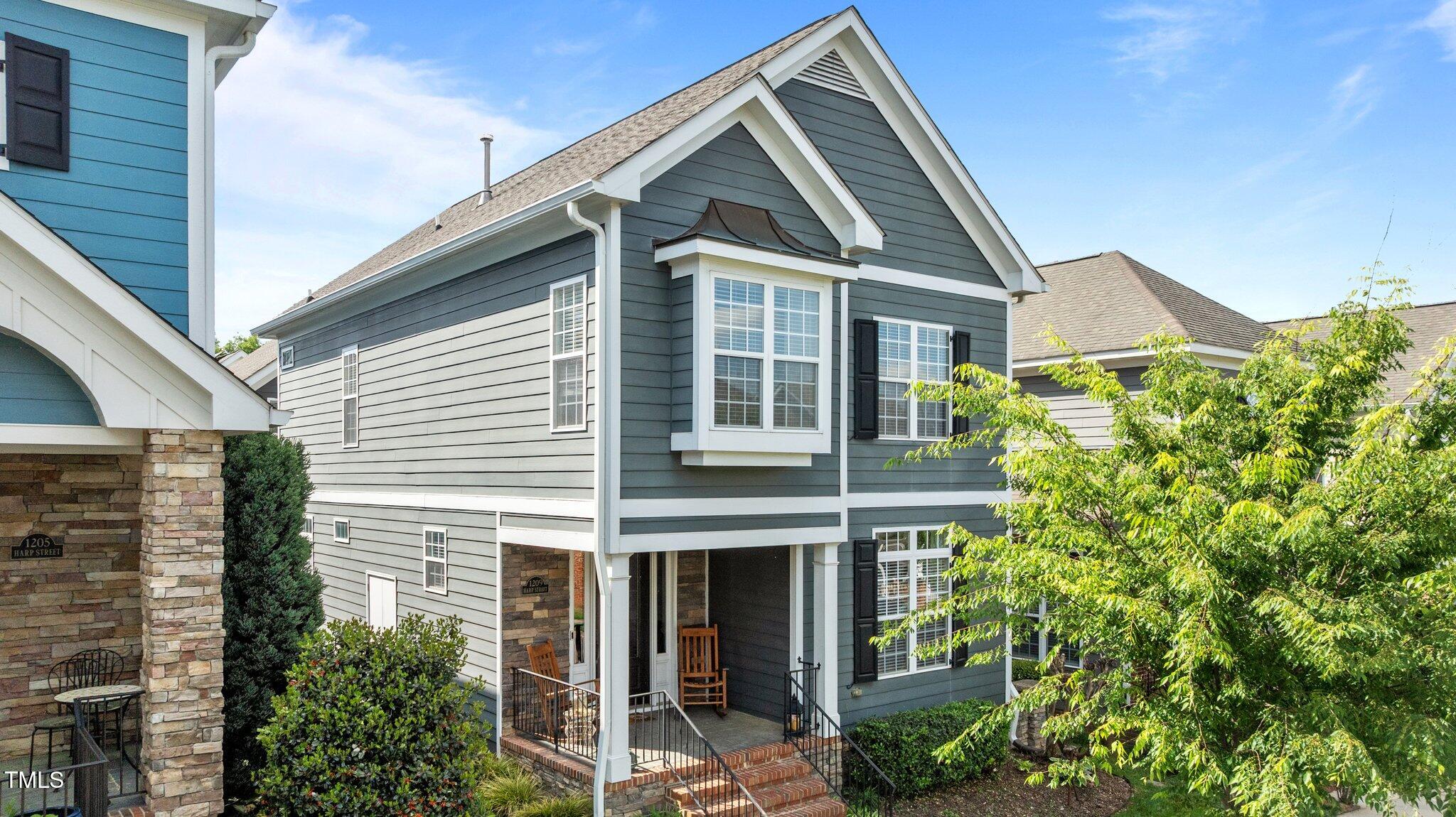 1209 Harp Street Raleigh, NC 27604 - Photo 2 of 39 a view of a house with potted plants and a large window
