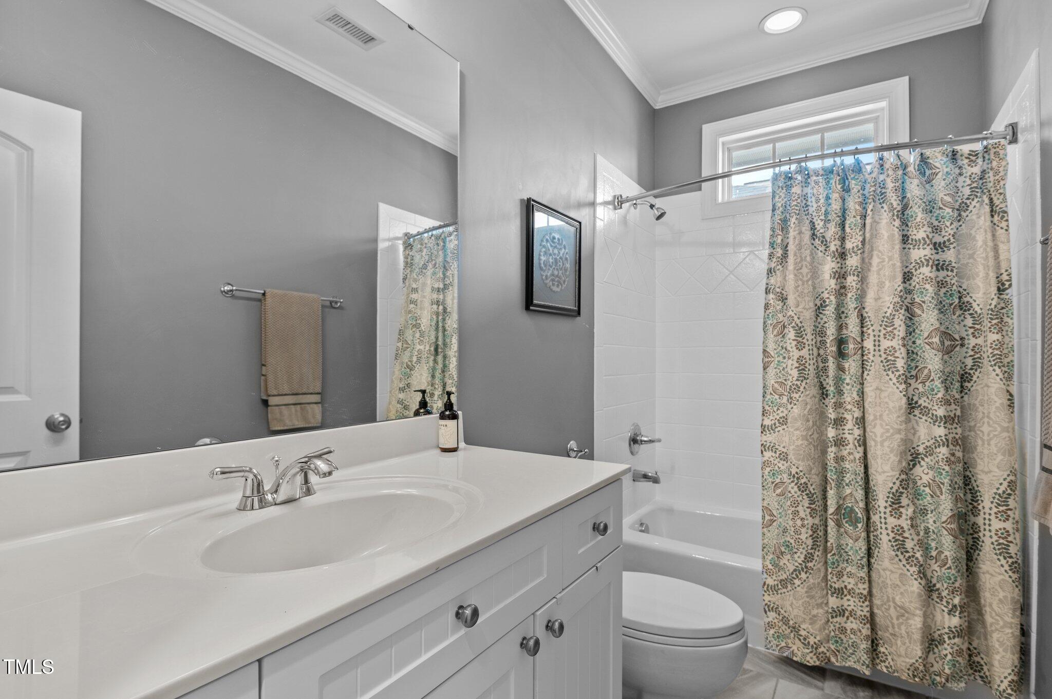 1209 Harp Street Raleigh, NC 27604 - Photo 29 of 39 a bathroom with a sink a toilet and shower