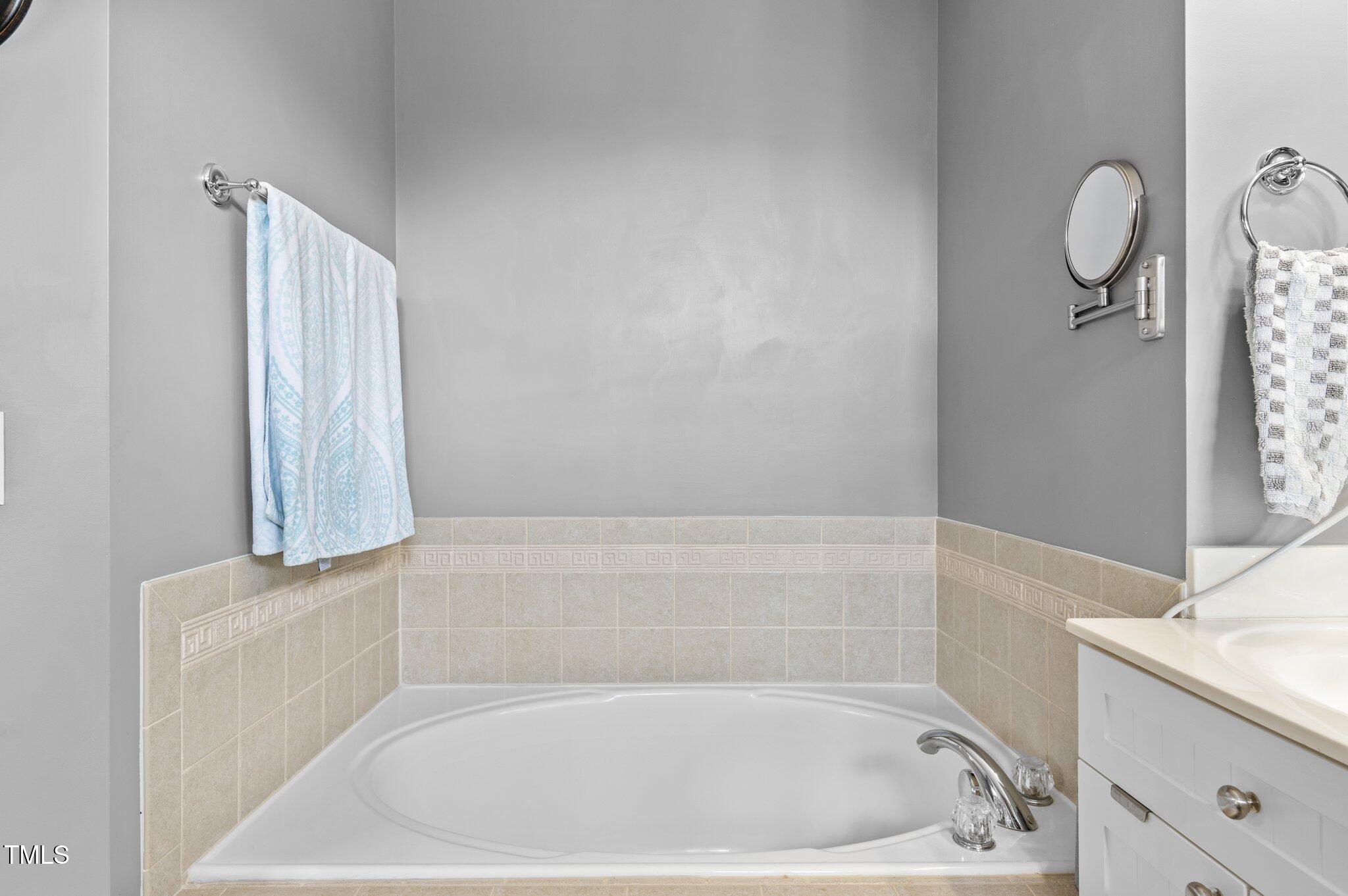 1209 Harp Street Raleigh, NC 27604 - Photo 33 of 39 a bathroom with a bathtub and a sink