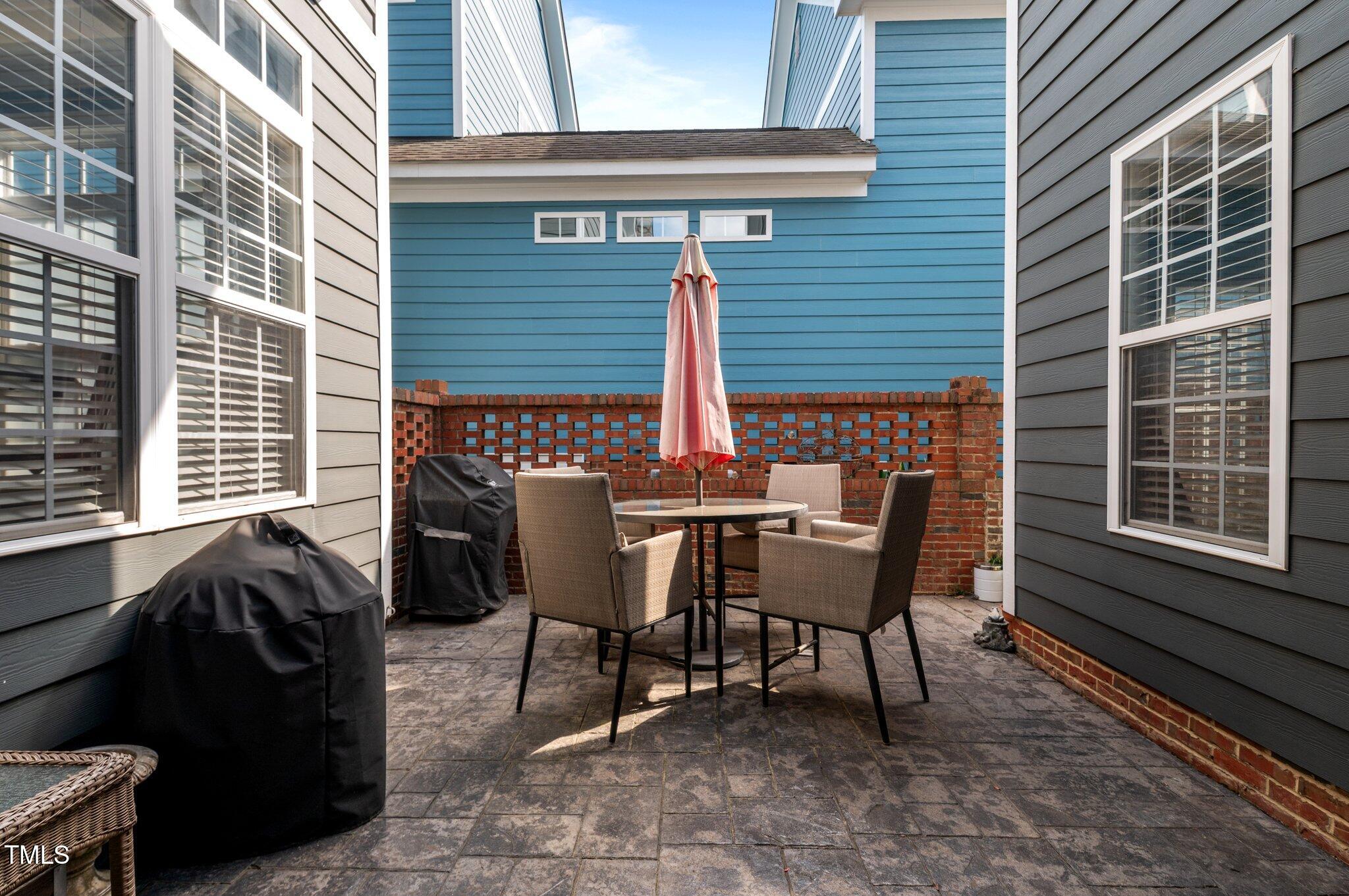 1209 Harp Street Raleigh, NC 27604 - Photo 36 of 39 a view of a patio with a table and chairs