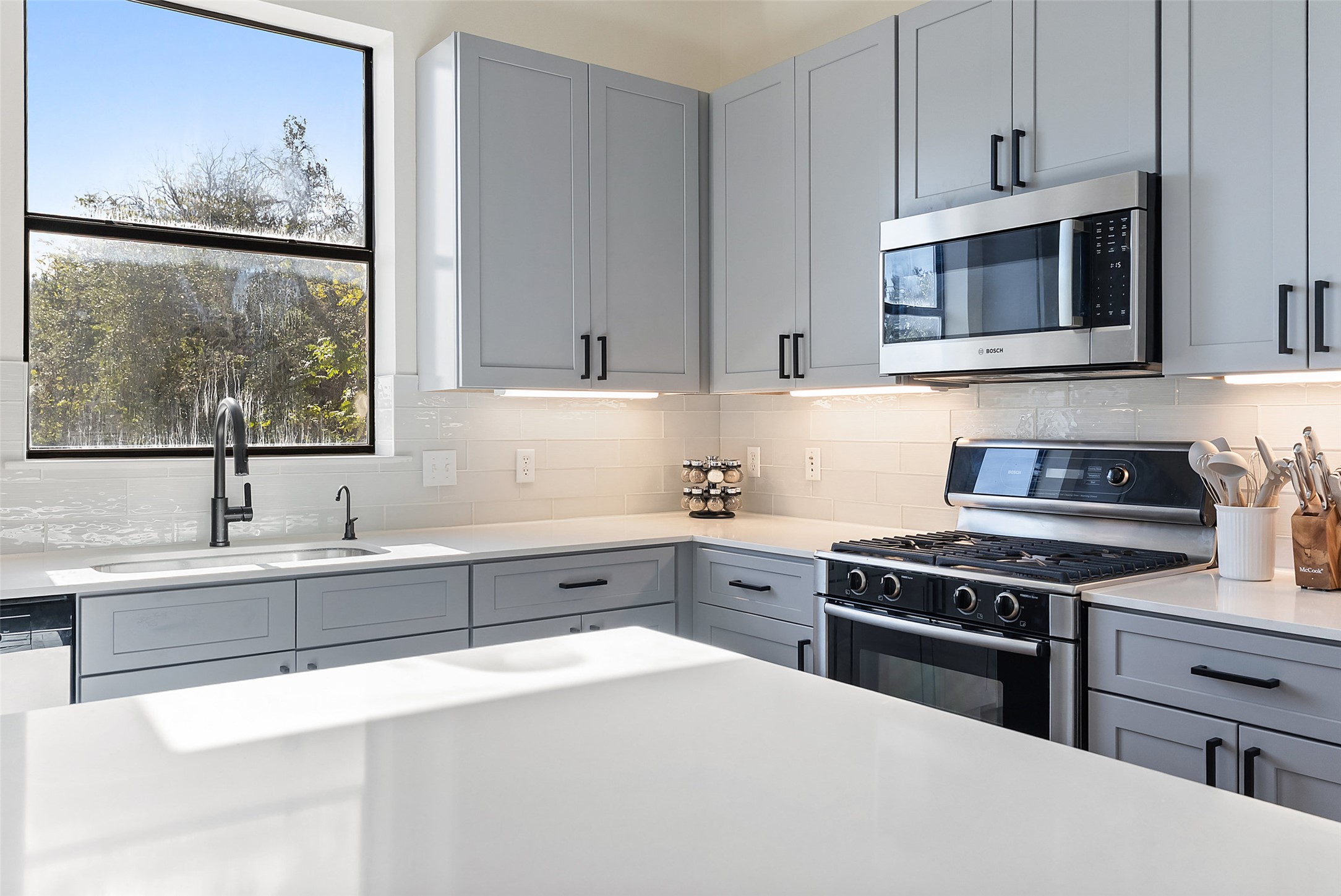 6000 South Congress Avenue, Unit 201 Austin, TX 78745 - Photo 9 of 23 a kitchen with stainless steel appliances a stove sink and cabinets