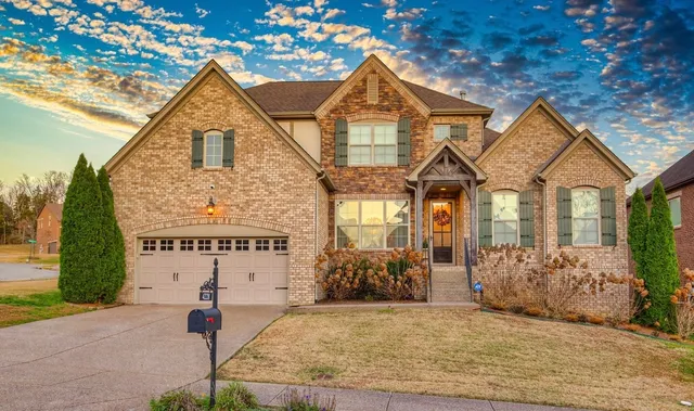 a view of a brick house with large windows