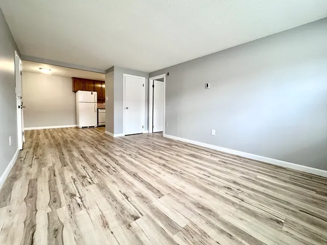 a view of a room with wooden floor and bathroom