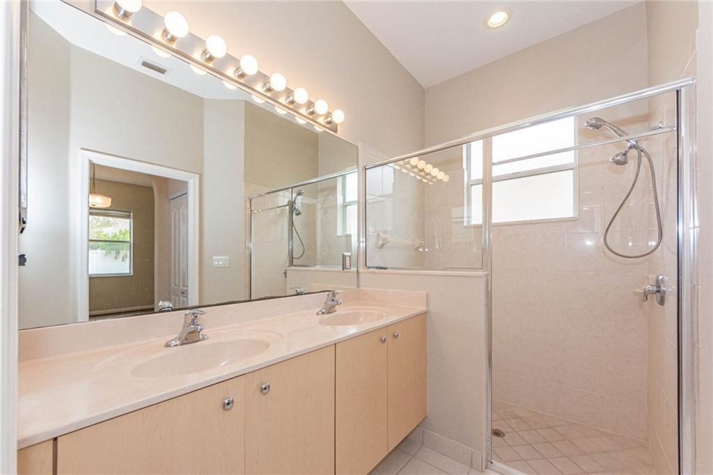 5544 Spanish River Road Fort Pierce, FL 34951 - Photo 19 of 35 a bathroom with a double vanity sink mirror and double