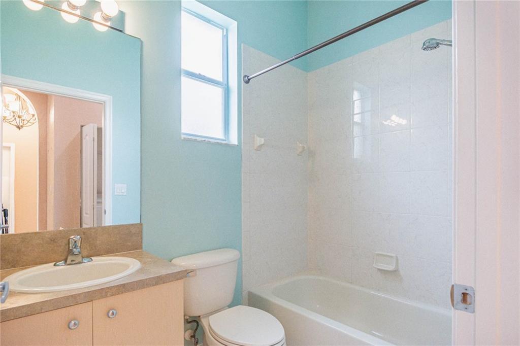5544 Spanish River Road Fort Pierce, FL 34951 - Photo 21 of 35 a bathroom with a granite countertop sink toilet and shower