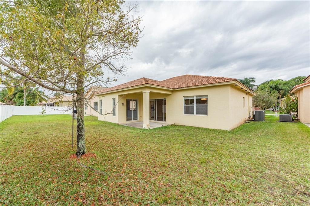5544 Spanish River Road Fort Pierce, FL 34951 - Photo 29 of 35 a view of a house with backyard and trees