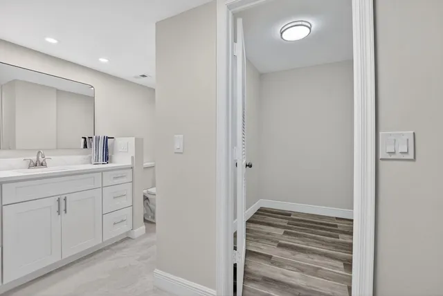 a view of kitchen and hall with wooden floor