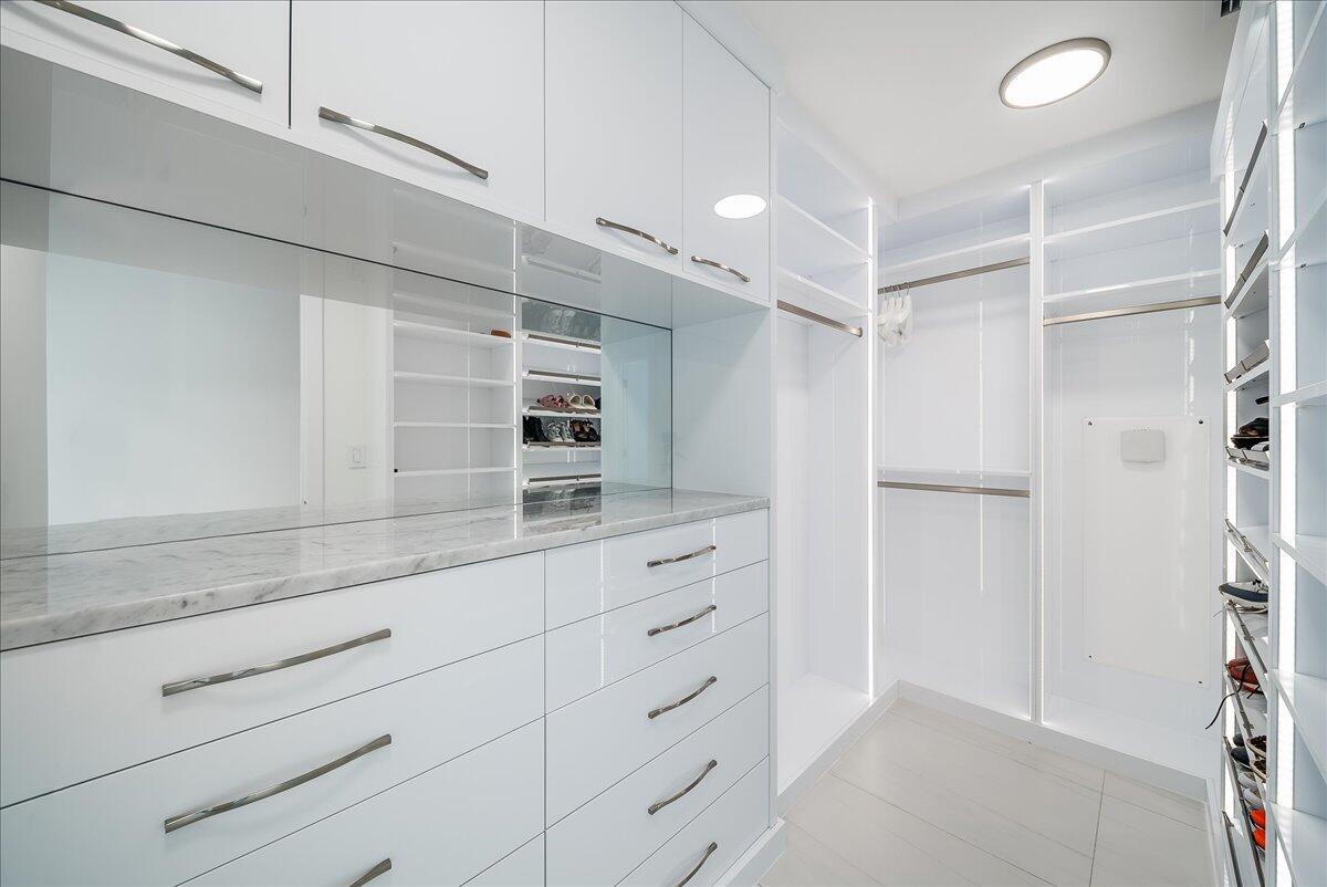 3100 North Ocean Drive, Unit P905 Singer Island, FL 33404 - Photo 13 of 42 a kitchen with white cabinets and refrigerator