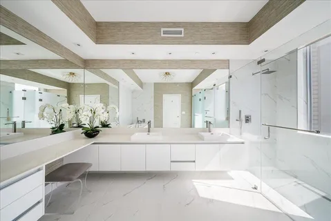 a bathroom with a tub shower and a sink