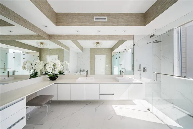 a bathroom with a tub shower and a sink
