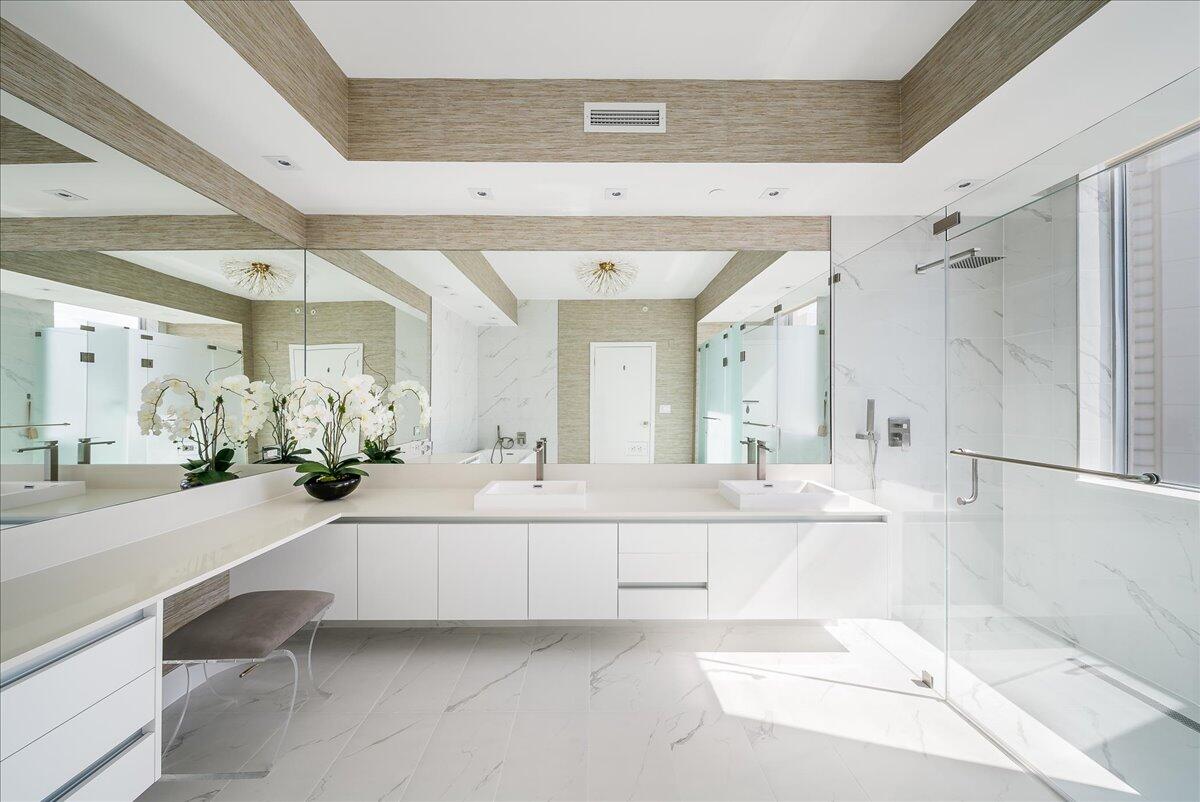 3100 North Ocean Drive, Unit P905 Singer Island, FL 33404 - Photo 15 of 42 a large white bathroom with a large mirror vanity and a shower