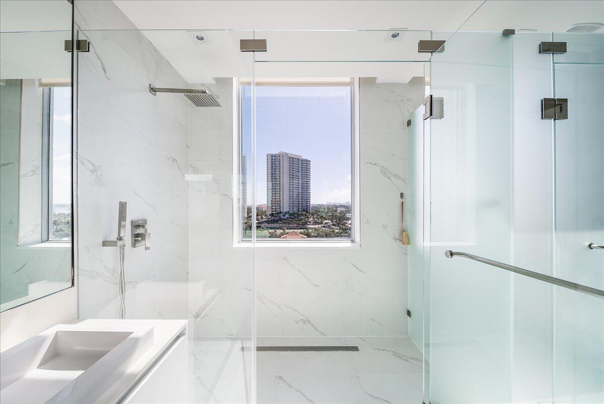 3100 North Ocean Drive, Unit P905 Singer Island, FL 33404 - Photo 16 of 42 a bathroom with a tub shower and a sink