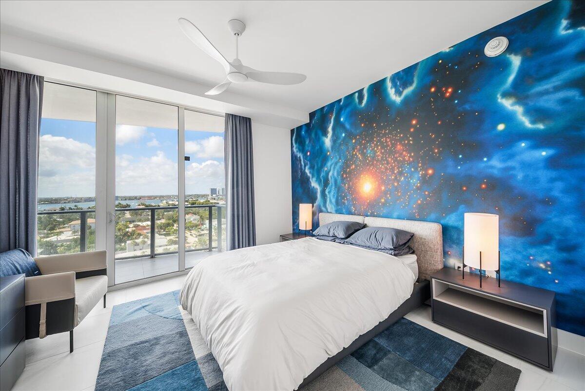 3100 North Ocean Drive, Unit P905 Singer Island, FL 33404 - Photo 19 of 42 a bedroom with a large bed and a large window