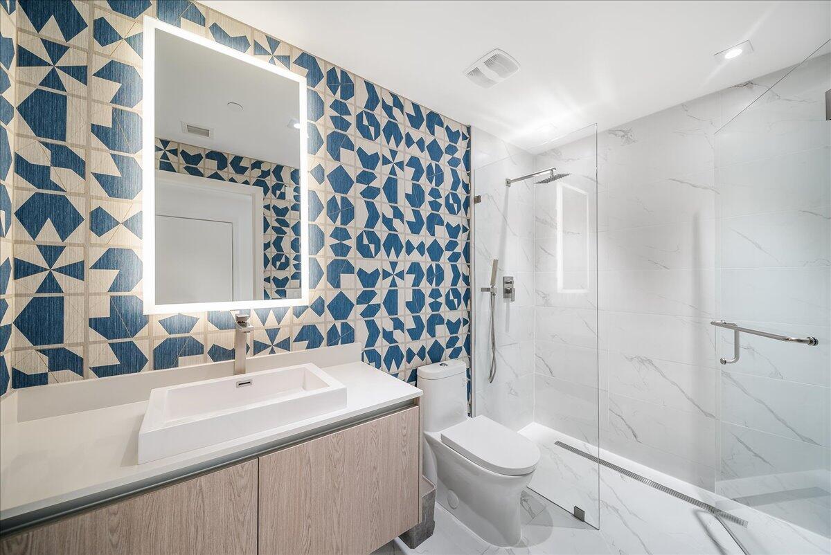 3100 North Ocean Drive, Unit P905 Singer Island, FL 33404 - Photo 20 of 42 a bathroom with a sink toilet and shower