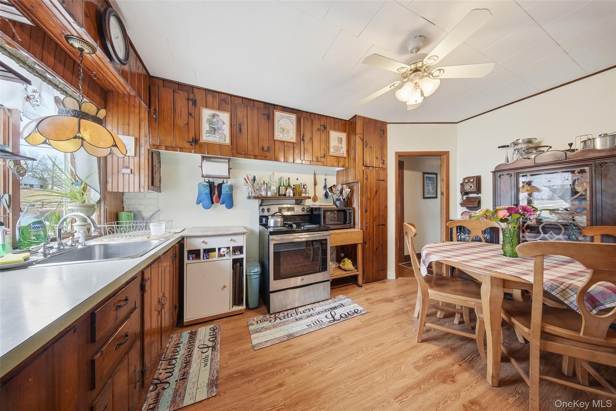 5003 Searsville Road Pine Bush, NY 12566 - Photo 11 of 40 a kitchen with stainless steel appliances kitchen island granite countertop a table chairs sink and cabinets