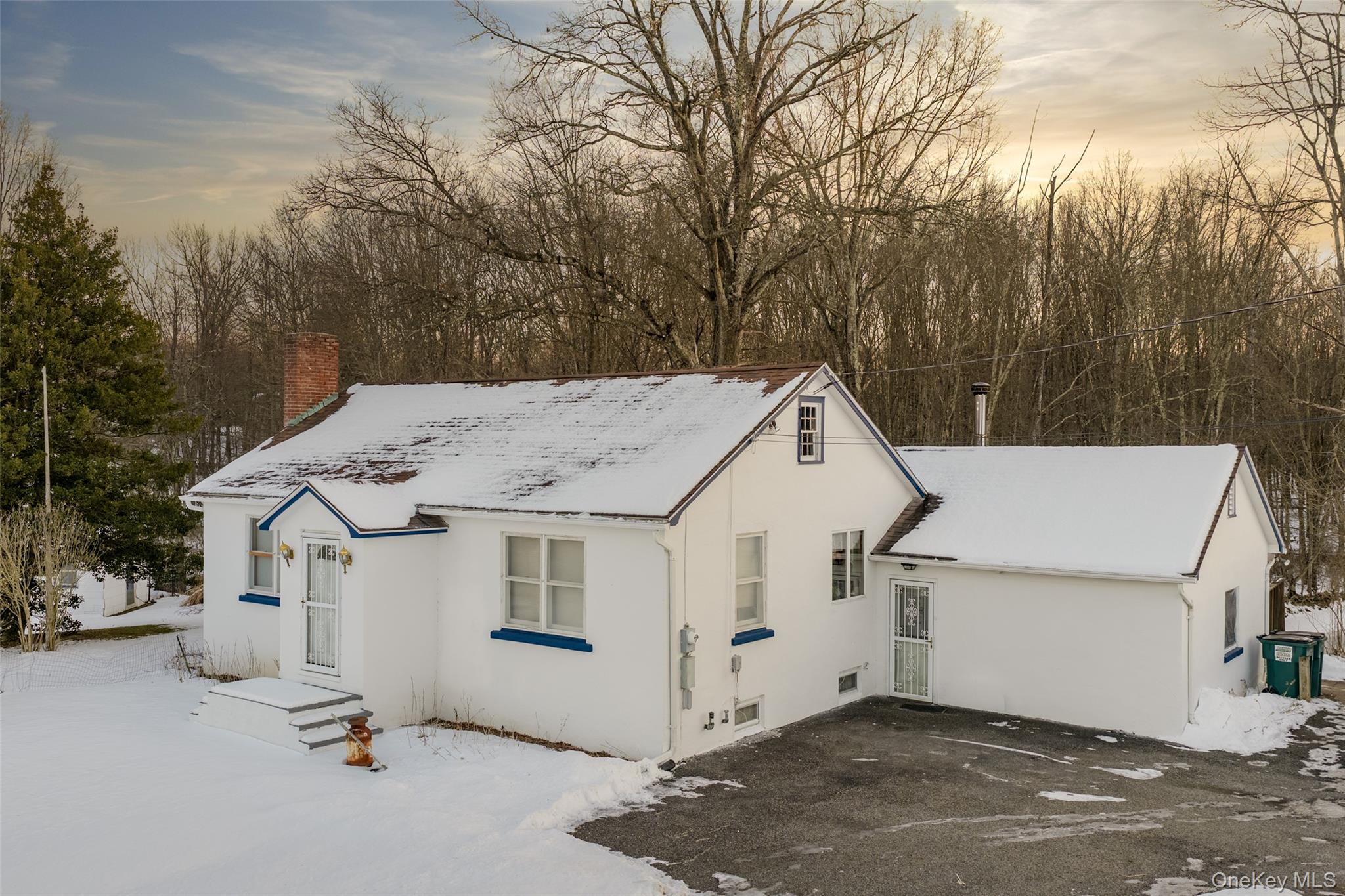 5003 Searsville Road Pine Bush, NY 12566 - Photo 2 of 40 a view of a white house with large trees and covered with tall trees
