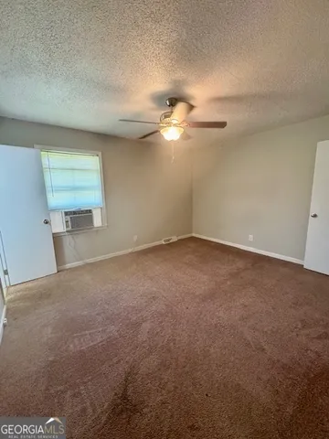 a view of a big room with carpet