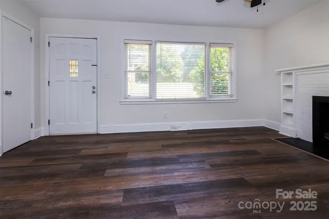 a room with a hardwood floor and a window