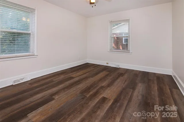 a view of a room with wooden floor and window