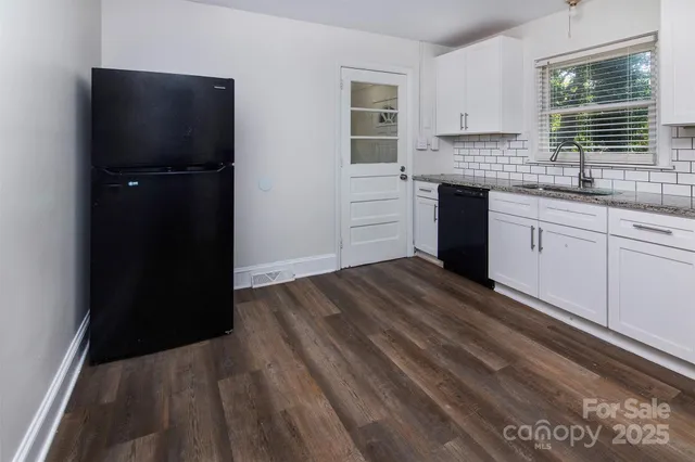 a kitchen with a refrigerator and window