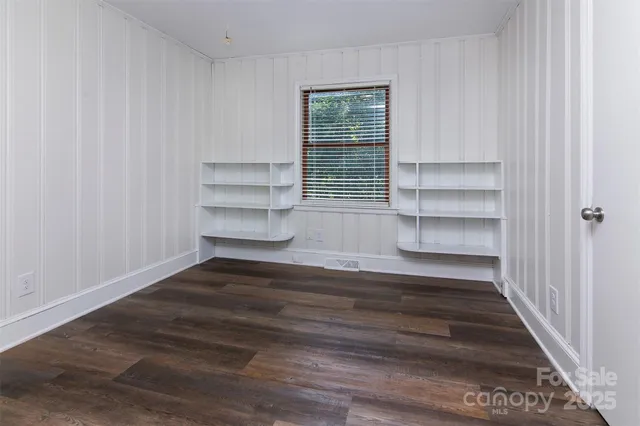 a view of a room with walk in closet and wooden floor