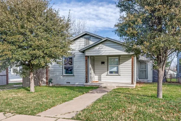 front view of a house with a tree
