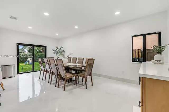 a dining room with furniture and window