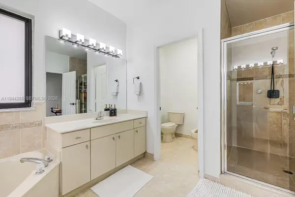 a spacious bathroom with a double vanity sink mirror and toilet