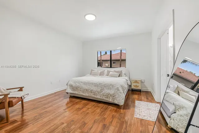 a bedroom with a bed and a table in it