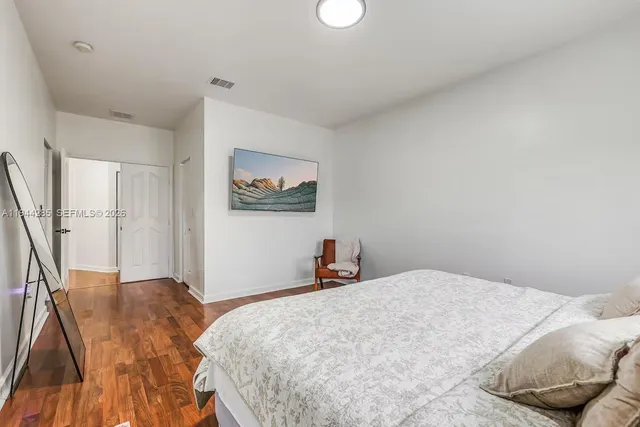a bedroom with a large bed and a chandelier