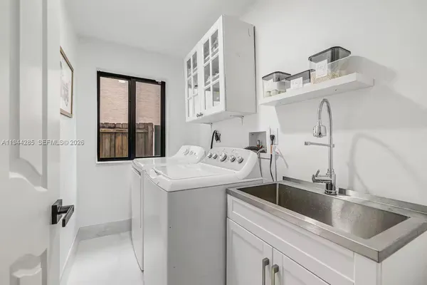 a kitchen with stainless steel appliances granite countertop a sink and dishwasher with white cabinets