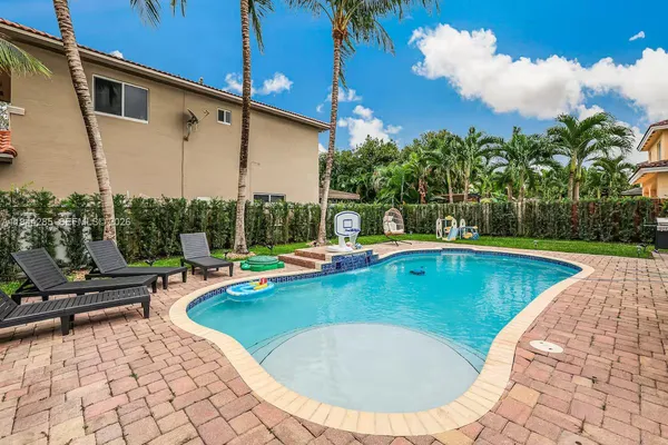 a view of a swimming pool with lounge chairs