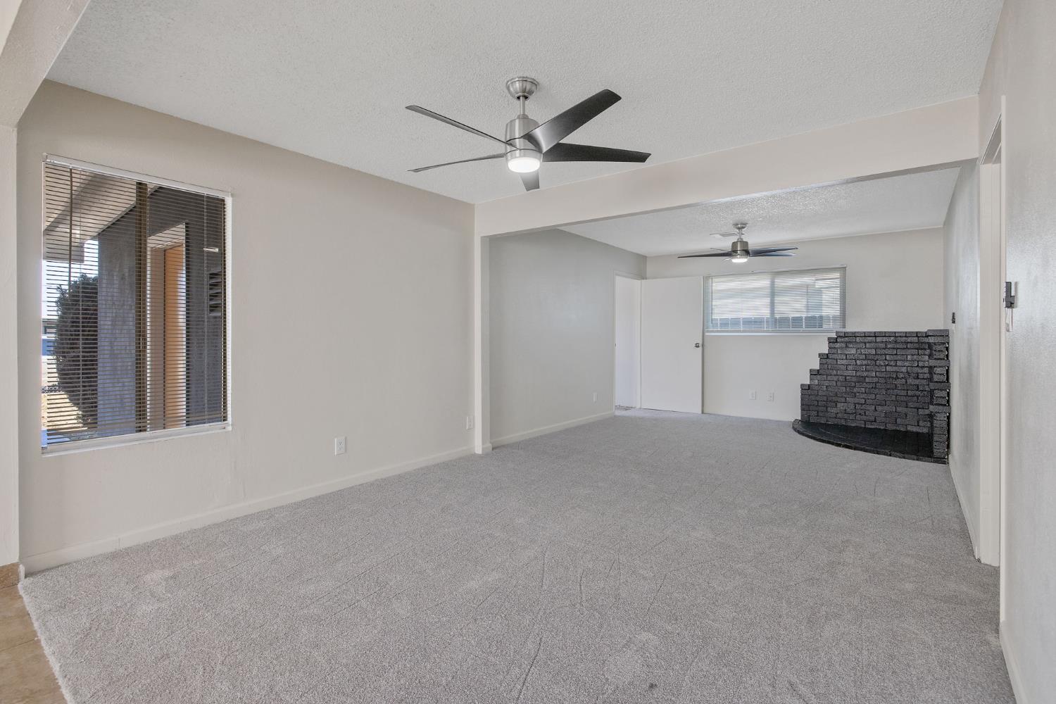 1432 North Locust Street Visalia, CA 93291 - Photo 13 of 37 a view of a livingroom with a ceiling fan and window