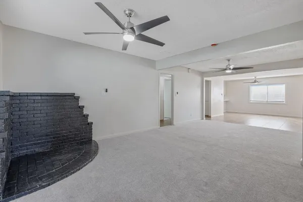 a view of an empty room and a window