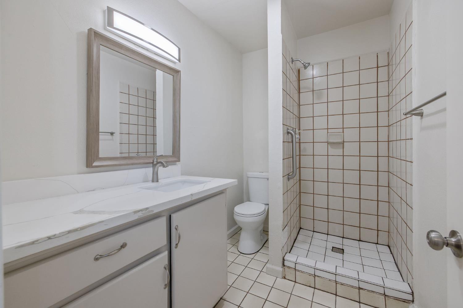 1432 North Locust Street Visalia, CA 93291 - Photo 20 of 37 a bathroom with a sink a toilet and a shower