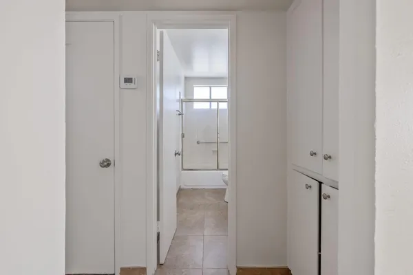 a view of an empty room with mirror