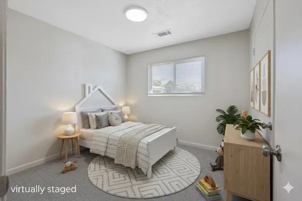 a bedroom with a bed and a potted plant