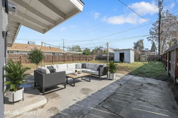 a view of a patio with couches and potted plants