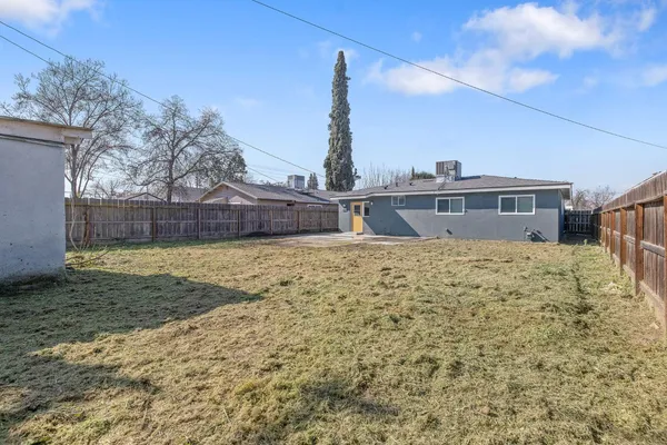 a view of house with a yard