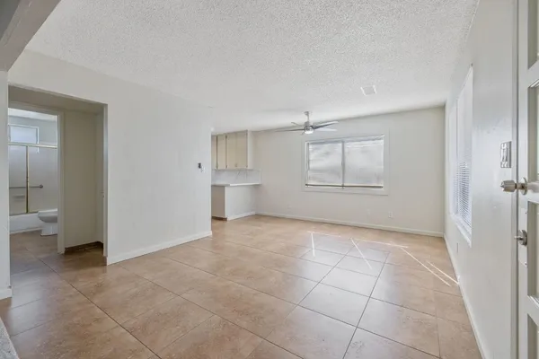 a view of an empty room and a bathroom