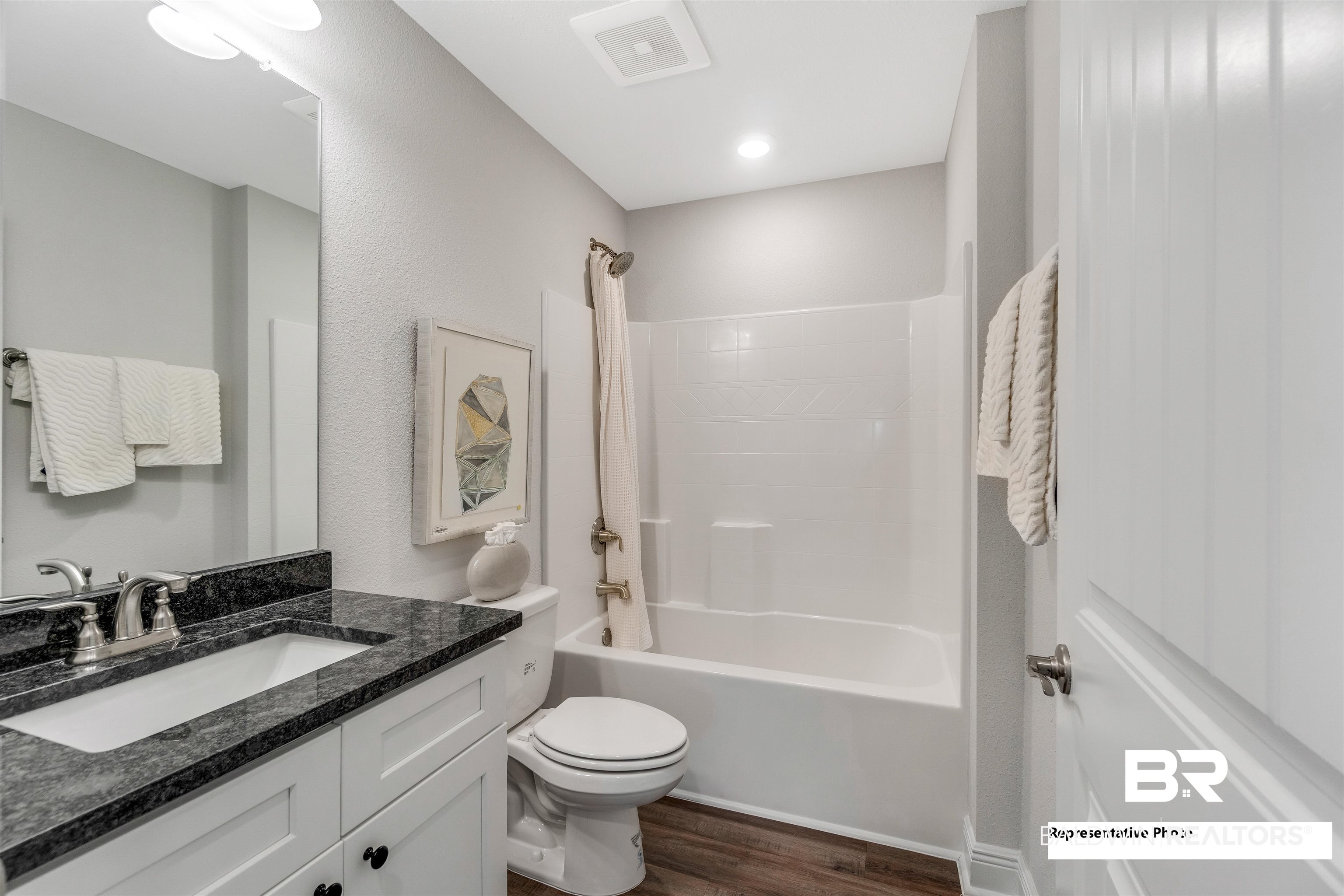 643 Mayflower Drive Foley, AL 36535 - Photo 15 of 34 Full bathroom featuring visible vents, toilet, wood finished floors, vanity, and shower / washtub combination
