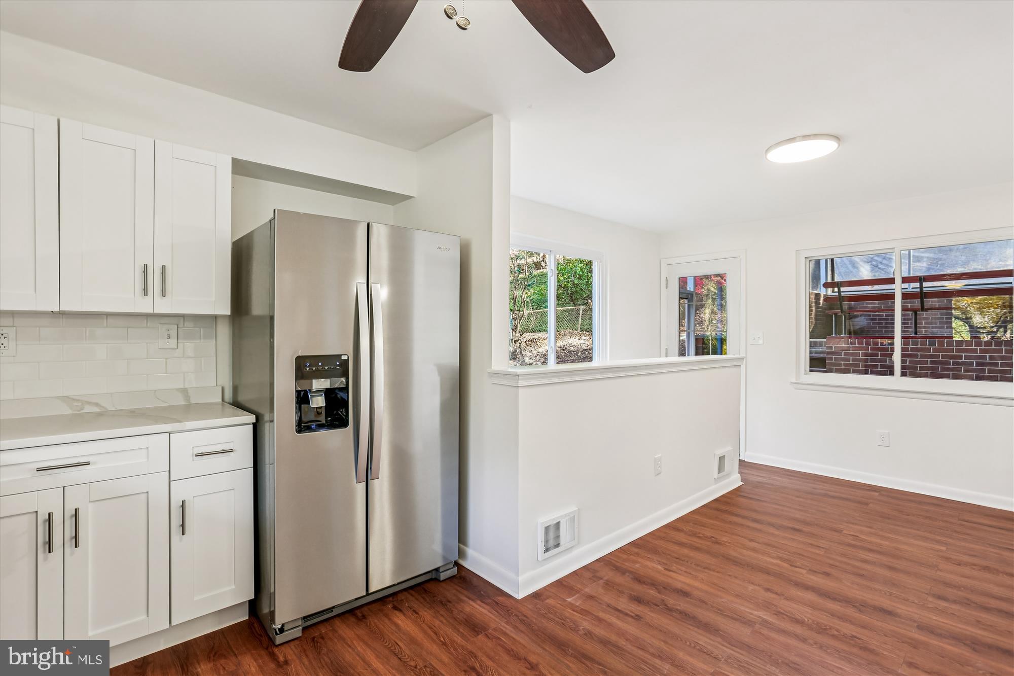 420 Lamberton Drive Silver Spring, MD 20902 - Photo 14 of 46 a kitchen with white cabinets and wooden floor