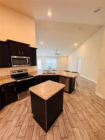 a large kitchen with a table and chairs in it