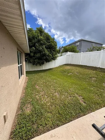 a view of a house with a backyard and a garden
