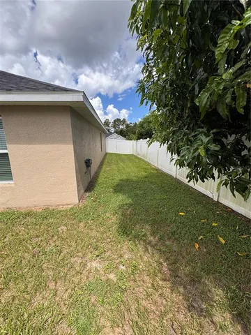 a view of a backyard with sitting area