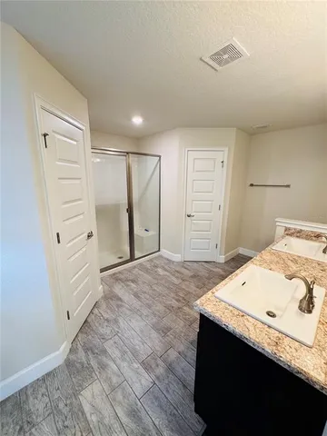 a bathroom with a granite countertop sink a mirror and a vanity