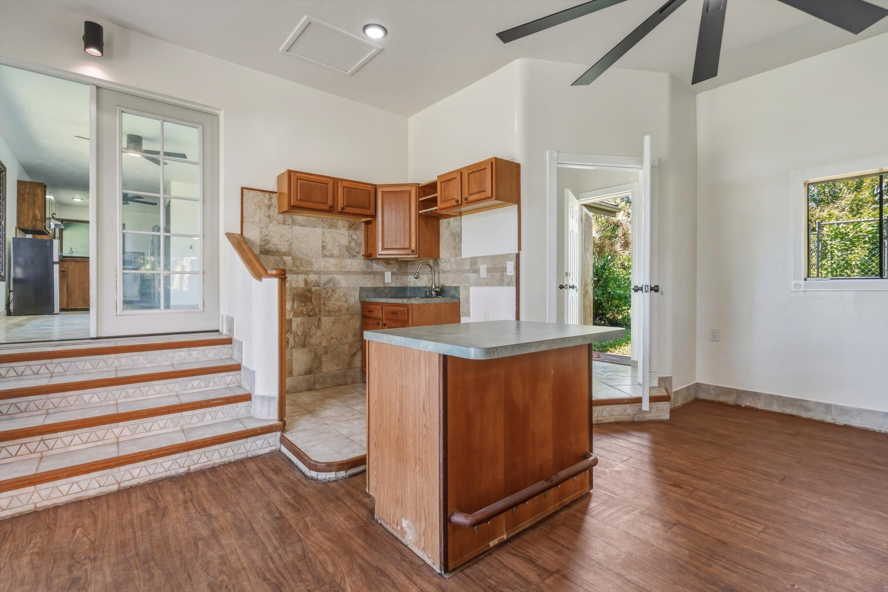 145 South Holokai Road Haiku, HI 96708 - Photo 13 of 50 a kitchen with stainless steel appliances granite countertop a stove a refrigerator and a wooden cabinets